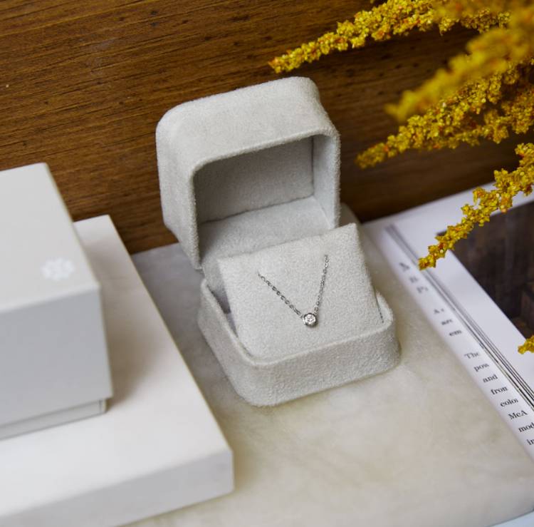 a necklace is sitting in a box on a table