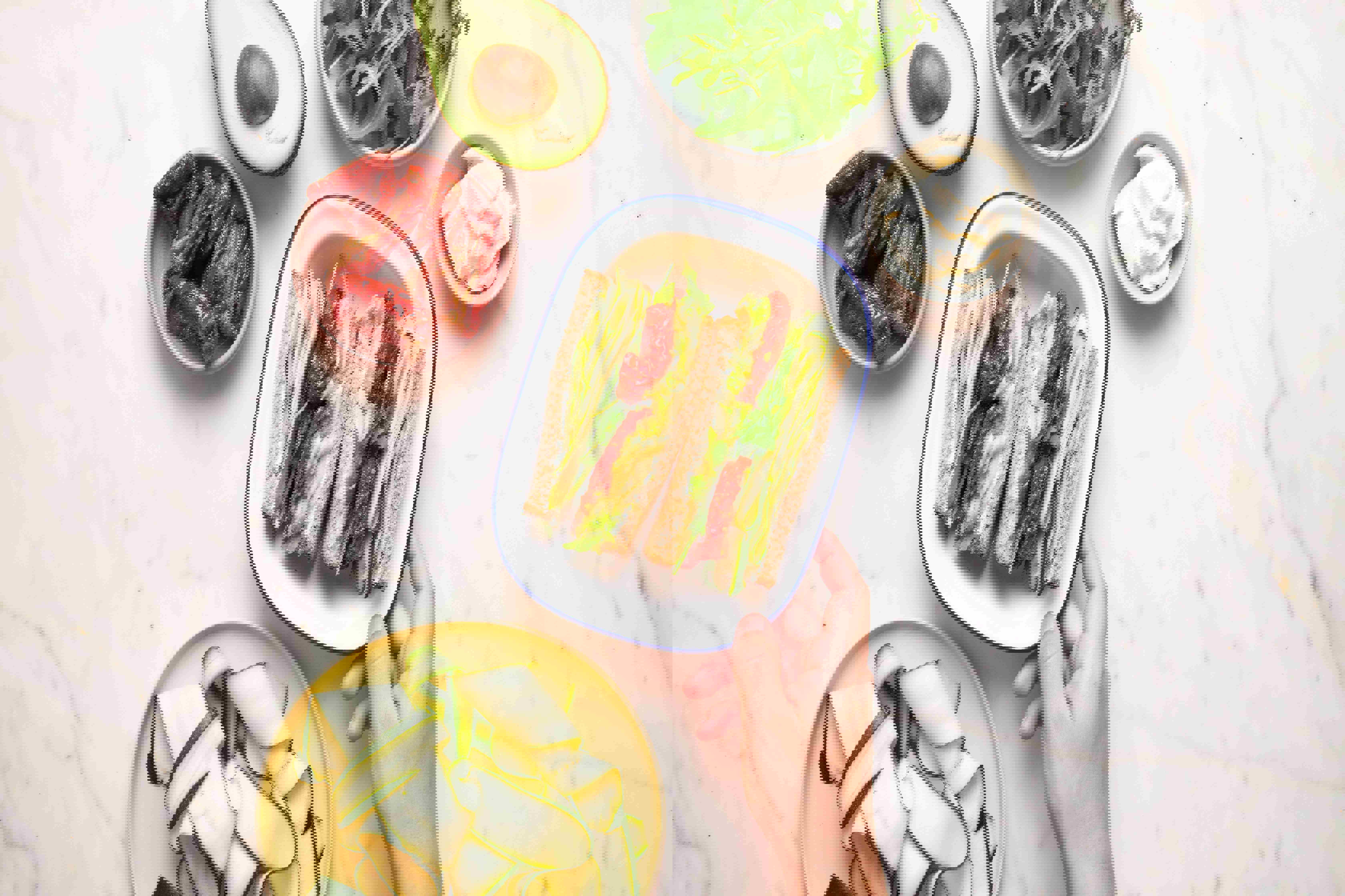 a person is holding a plate of food with a sandwich on it